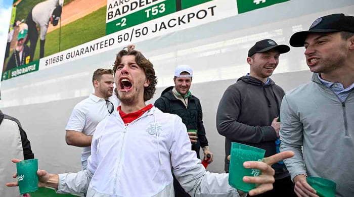Fans celebrate off the 16th green during the continuation of the second round of the WM Phoenix Open at TPC Scottsdale on Saturday, Feb. 10, 2024.